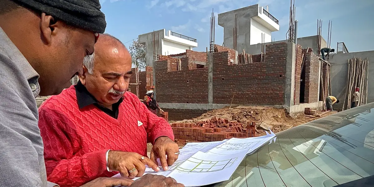 Architects reviewing drawings at a building site