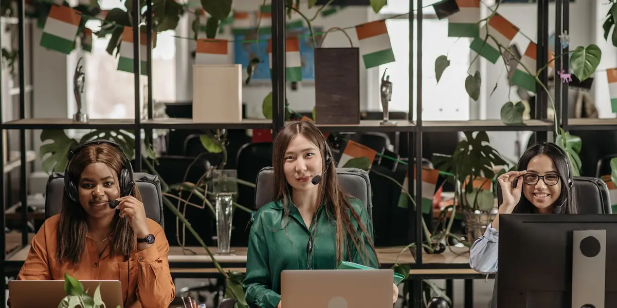 A calling team with headsets at their desks