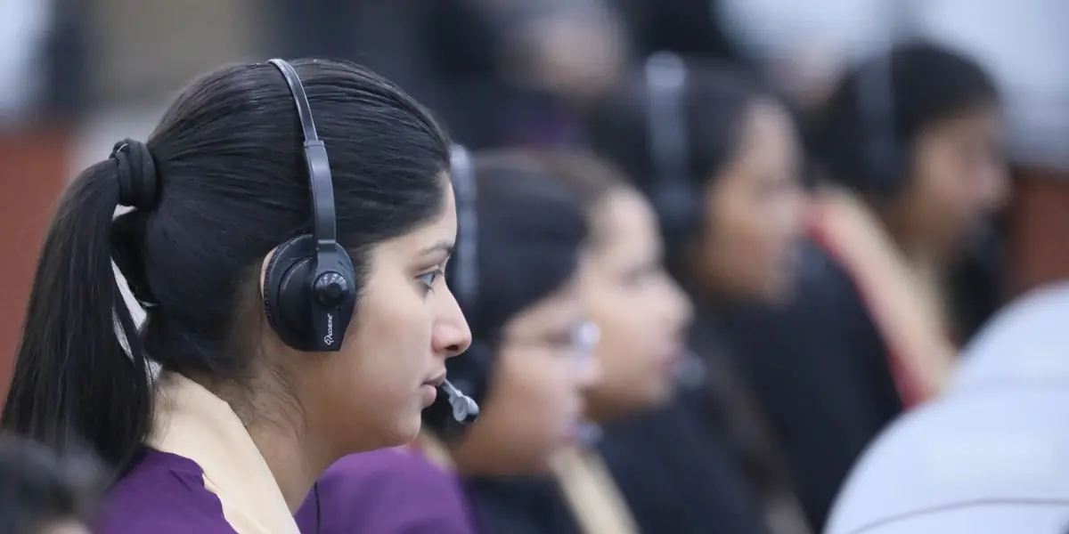A row of calling agents with headsets