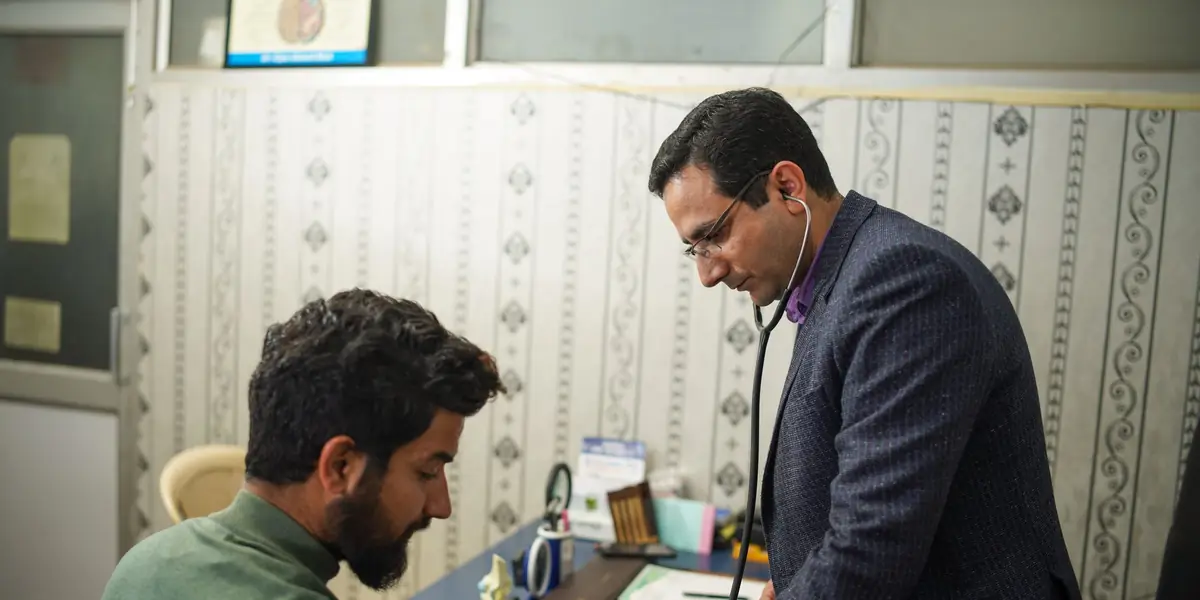 A doctor with a patient in a clinic consulting room