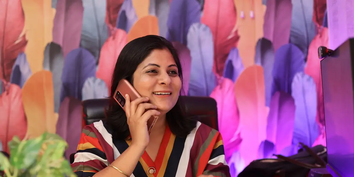 A business owner taking a call at her desk