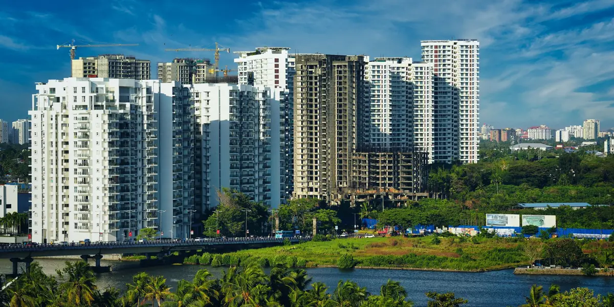 High-rise apartment towers beside a lake in an Indian city