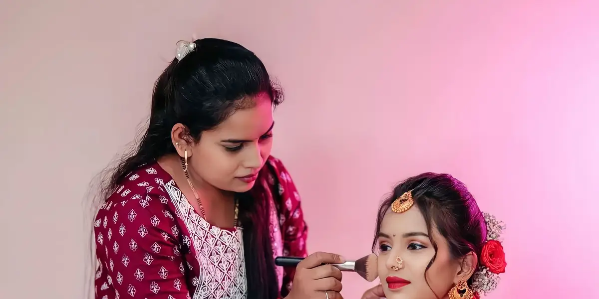A make-up artist getting a client ready in a salon
