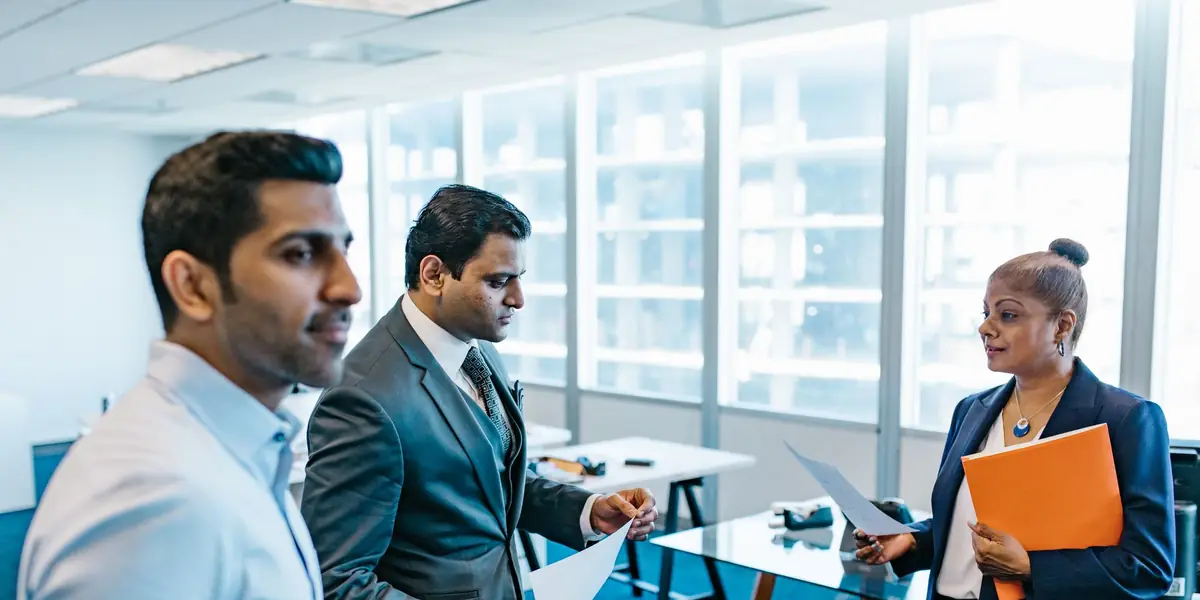 A hiring team going through candidates’ papers
